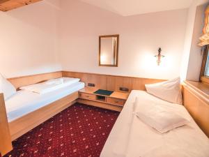 a room with two beds and a bath tub at Hotel Andrea 3-Sterne Superior in Gerlos