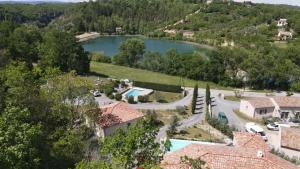 an aerial view of a house with a lake at Location avec piscine Sud Ardèche in Berrias Et Casteljau