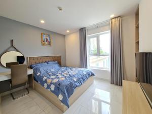 a bedroom with a bed and a desk and a window at Bearshouse - Terra Royal in Ho Chi Minh City