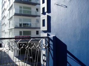 a building with a blue and white wall and a balcony at Abra Marina Hotel in Mar del Plata