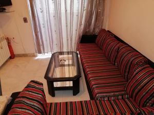 a living room with a couch and a coffee table at Palmeraies vacances Tunis in La Marsa
