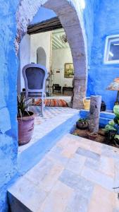 a room with a blue wall and a patio at Dar Lekbira Boutique Hôtel in Sousse