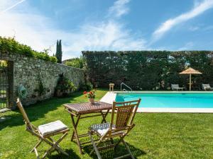 a table and chairs next to a swimming pool at Rovezzano B&B in Florence