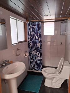 een badkamer met een wit toilet en een wastafel bij KOSKO Casa Hotel in Cuzco
