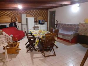 a living room with a table and chairs and a couch at STRETT in Campobasso