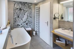ein Badezimmer mit einer Badewanne und einem Waschbecken in der Unterkunft Haus Welzel in Dresden