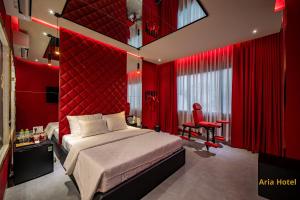 a red bedroom with a bed and a red wall at Aria Hotel Quận 10 in Ho Chi Minh City