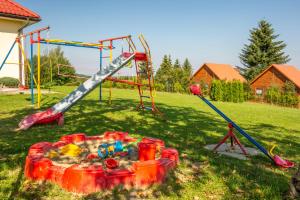 a group of playground equipment in a field at Zielona Plaża in Bereżnica Wyżna