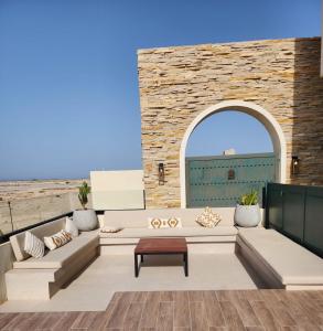 a patio with a couch and a table at The Gate in Sur