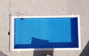 a blue swimming pool with stairs in a room at BLU OCEANO (Casa Vacanza) in Guardialfiera +15 photos
