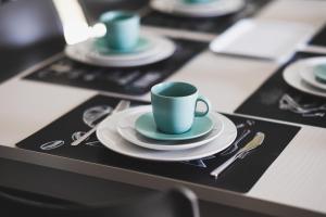 a table with blue cups and plates and silverware at BLU OCEANO (Casa Vacanza) in Guardialfiera