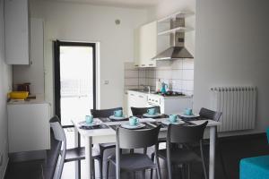 ein Esszimmer mit einem Tisch und Stühlen in einer Küche in der Unterkunft BLU OCEANO (Casa Vacanza) in Guardialfiera