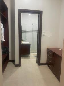 a bathroom with a door leading to a sink at Dar Villa in Dar es Salaam +32 photos
