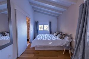 a white bedroom with a bed and a window at Wood Chalet 1 Monaco Forest La Turbie - Sleeps 5 people in La Turbie