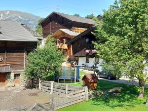 ein Holzhaus mit einem Zaun davor in der Unterkunft Ferienwohnung Dienerhof in Großkirchheim
