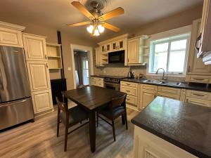 a kitchen with a table and a ceiling fan at THE RED STAR ROOM A in Niagara Falls
