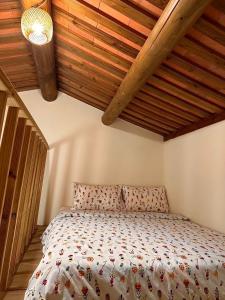 a bedroom with a bed with a wooden ceiling at Yong Le Homestay in Jincheng
