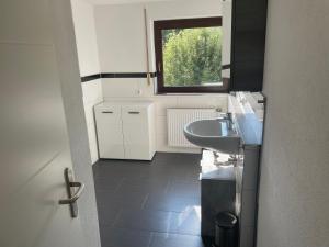 a small bathroom with a sink and a window at Ferienhaus in Amstetten in Amstetten +11 photos