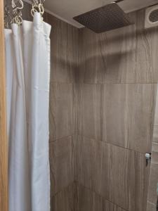 a shower with a white shower curtain in a bathroom at 31 Elwyn Road in March