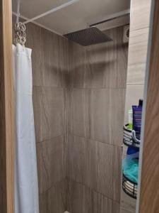 a bathroom with a shower with a white shower curtain at 31 Elwyn Road in March