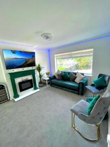 a living room with a couch and a fireplace at White House Villa in Nottingham