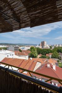 a view of roofs of buildings from a balcony at Apartman Centar in Niš