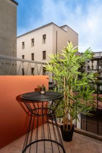 a black table on a balcony with plants at Camelia Rooms Venice Guesthouse in Mestre