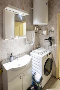 a bathroom with a sink and a washing machine at Apartman Centar in Niš +24 photos