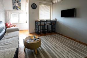 a living room with a couch and a table at Apartman Centar in Niš