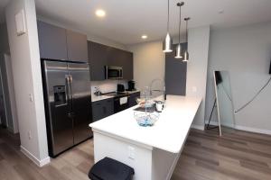 a kitchen with a white counter and a refrigerator at Comfortable Getaway Downtown Htx in Houston