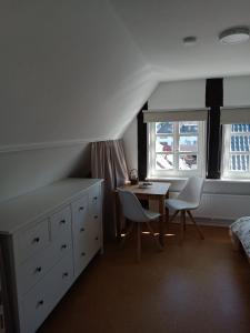 1 dormitorio con 1 cama, mesa y sillas en Fischerhaus Herstelle, en Beverungen