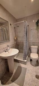 a bathroom with a sink and a toilet at PUEBLO in Benalmádena