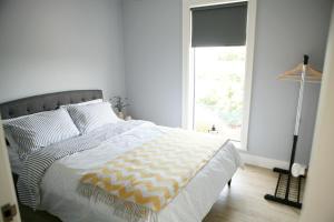 a bedroom with a large bed with a window at Ocean Breeze in Cork