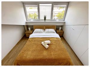 a small bedroom with a bed with a towel on it at Apartaments in the city centre in Kaunas