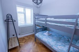 a bedroom with two bunk beds and a window at Cosy Eton Escape with parking. in Eton