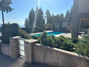 a backyard with a fence and a swimming pool at Luxury accomodation in West Vancouver in West Vancouver