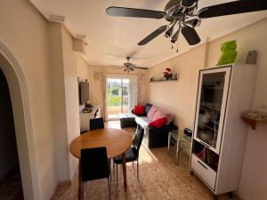 een woonkamer met een tafel en een bank bij Saint James Park upstairs in Orihuela-Costa