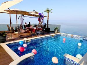 a swimming pool with balls in the water at Apart Lux Beciragic in Dobra Voda