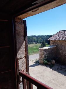 an open door of a building with a view of a field at Les chambres de Solol in Félines