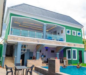 a house with a swimming pool in front of it at Akure Airport Hotel in Oba Ile