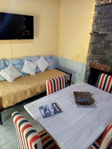 a living room with a table and a couch at CABAÑAS EL CAMINO in San Luis