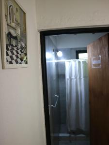 a bathroom with a shower and a glass door at CABAÑAS EL CAMINO in San Luis