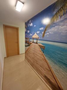 a room with a mural of a pier and the ocean at Apartamento en Miami Platja - Tarragona in Miami Platja
