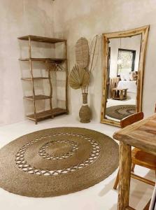 a room with a large rug and a mirror at Angatu Villas 2 Padang Padang in Uluwatu +13 photos