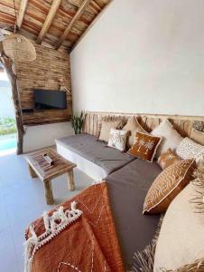 a living room with a couch and a table at Angatu Villas 2 Padang Padang in Uluwatu