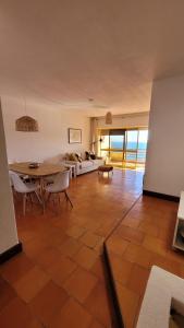 a living room with a table and a couch at Casa Amarela _ Sesimbra in Sesimbra