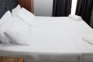 a white bed with two white pillows on it at Avist Hotel Avcılar in Avcılar