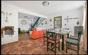 a living room with a table and chairs and a couch at Casa la limosna in Setenil