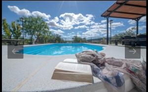a swimming pool with a sign in front of it at Casa la limosna in Setenil