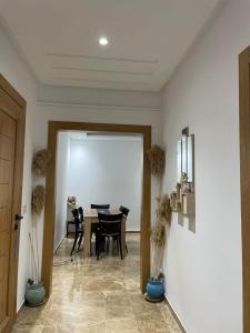 a dining room with a table and a dining roomiasm at Lux appartment khezama sousse in Sousse